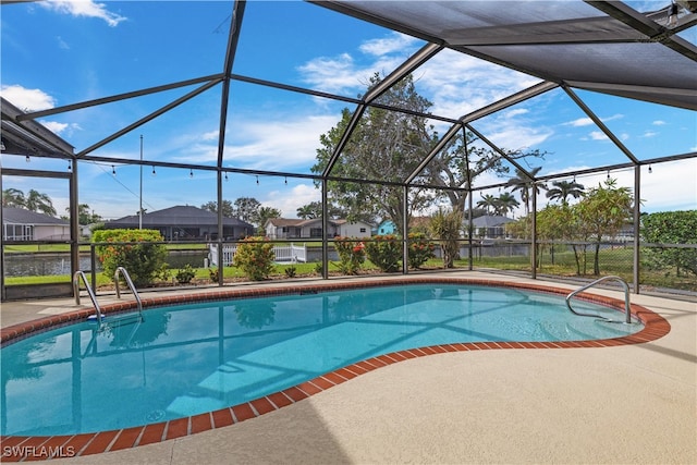 view of swimming pool with a patio and a lanai