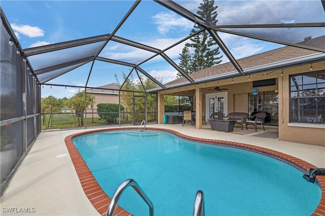 view of swimming pool with a patio area, a lanai, and ceiling fan