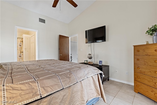 bedroom with ceiling fan, vaulted ceiling, light tile patterned floors, and ensuite bathroom