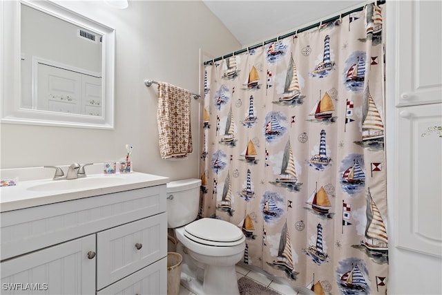 bathroom with vanity, toilet, walk in shower, and tile patterned flooring