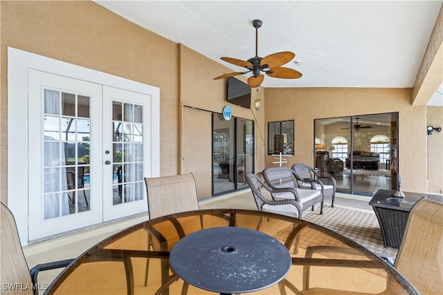 sunroom / solarium featuring french doors and ceiling fan