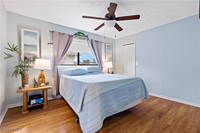 bedroom with a closet, ceiling fan, and hardwood / wood-style flooring