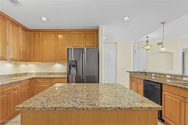 kitchen featuring stainless steel fridge, a center island, decorative light fixtures, and light stone counters