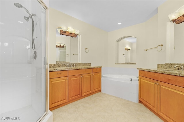 bathroom with tile patterned floors, vanity, and separate shower and tub