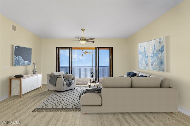 living room featuring ceiling fan and light hardwood / wood-style flooring