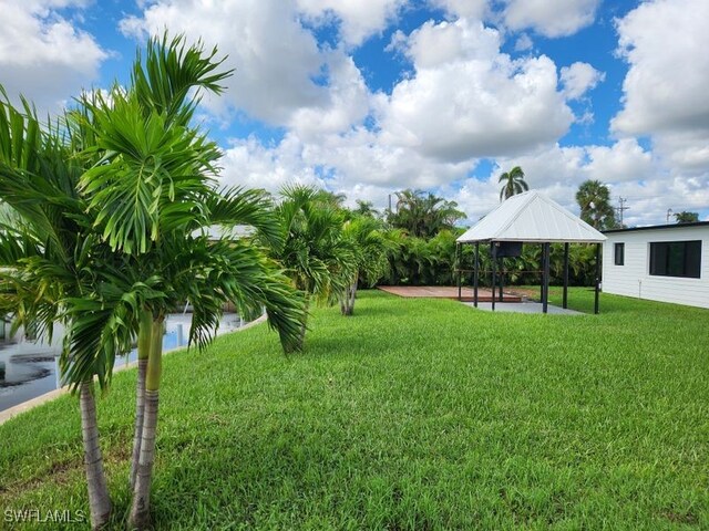 surrounding community featuring a gazebo, a lawn, and a patio area