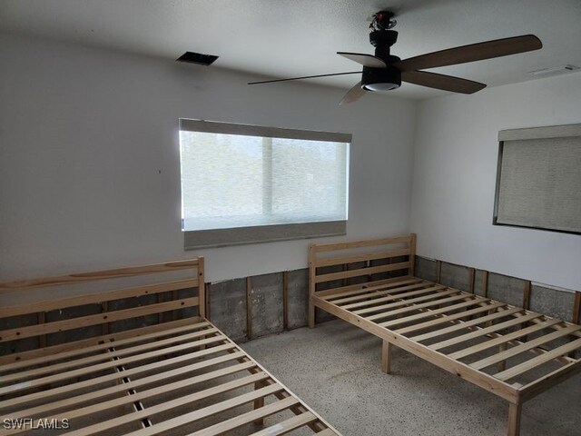 unfurnished bedroom featuring ceiling fan