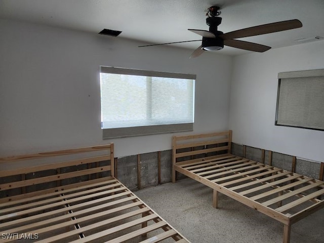 unfurnished bedroom with visible vents and ceiling fan