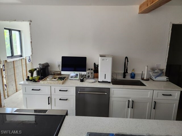 kitchen with white cabinets, sink, and black dishwasher