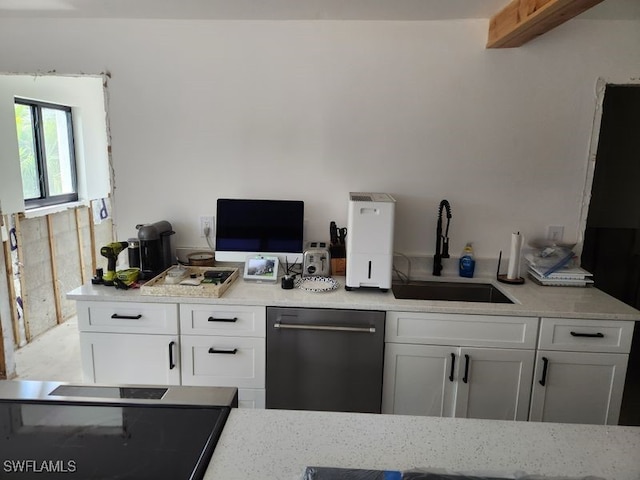 kitchen with a sink, dishwasher, and white cabinets