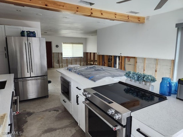 kitchen with visible vents, white cabinetry, stainless steel appliances, and light countertops