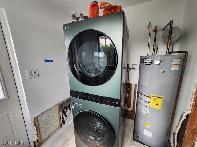 washroom featuring water heater and stacked washer / dryer