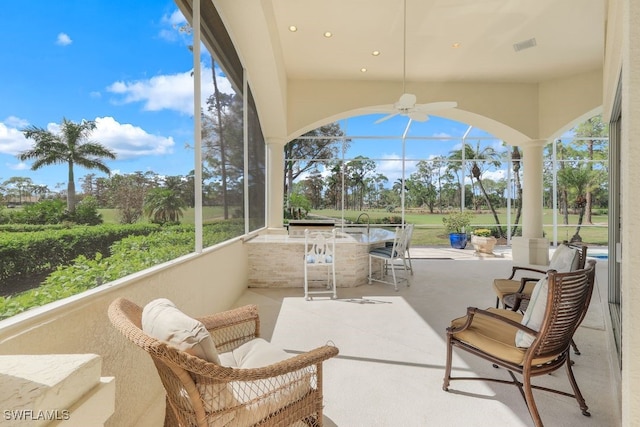 sunroom featuring visible vents and ceiling fan