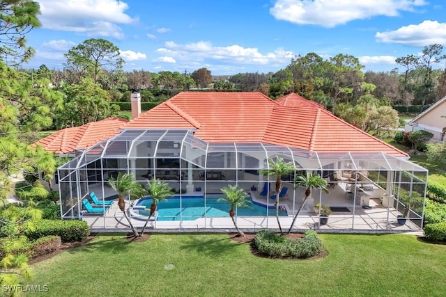 pool with a patio, a yard, and a lanai