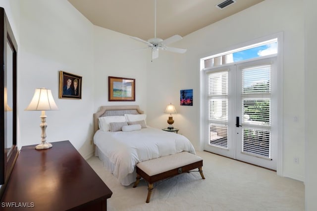 bedroom featuring access to exterior, light colored carpet, visible vents, and a ceiling fan