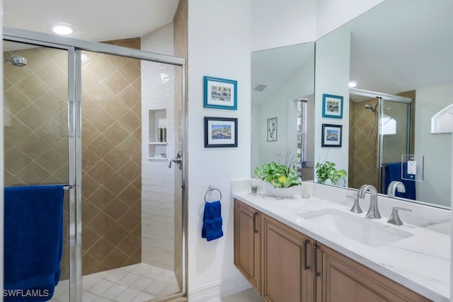 full bath with a stall shower and vanity