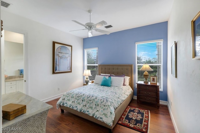 bedroom featuring wood finished floors, visible vents, and baseboards