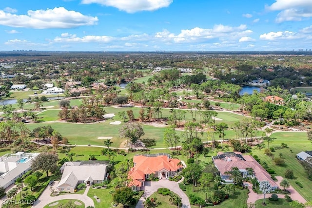 drone / aerial view with a residential view, a water view, and golf course view