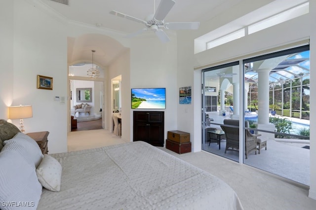 carpeted bedroom with a high ceiling, multiple windows, and access to exterior