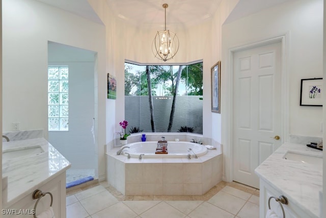 bathroom featuring a bath, tile patterned flooring, vanity, and a healthy amount of sunlight