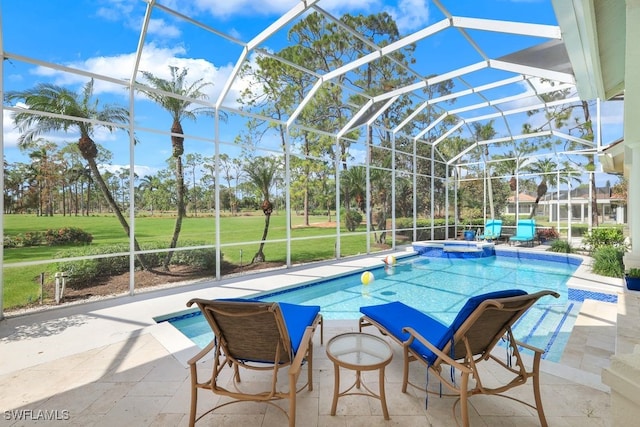 view of pool featuring a pool with connected hot tub, a lanai, and a patio