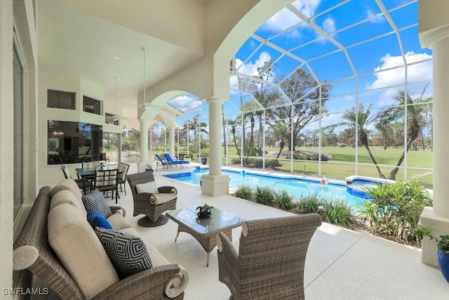 view of patio with glass enclosure, a pool with connected hot tub, and outdoor lounge area