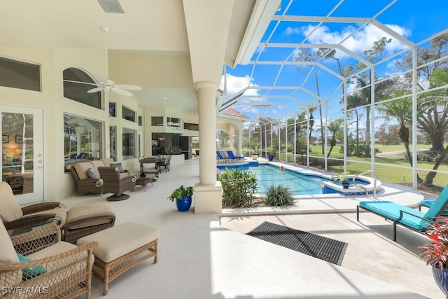 view of swimming pool with a ceiling fan, a lanai, a patio, and an outdoor living space