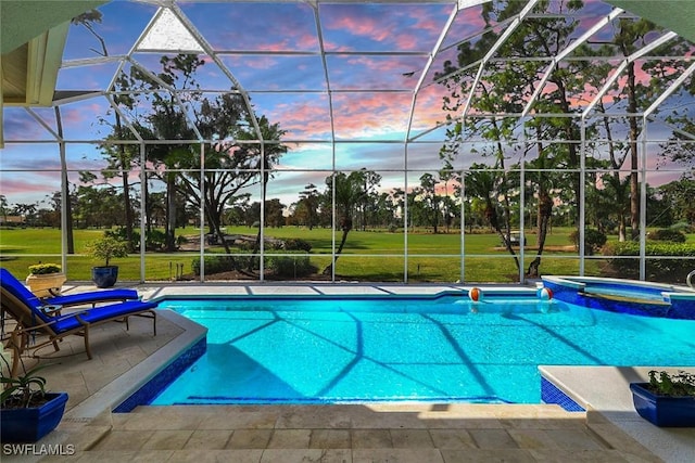 view of pool featuring glass enclosure, a yard, a patio, and a pool with connected hot tub