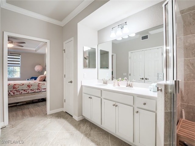 bathroom featuring vanity, a shower with door, tile patterned floors, crown molding, and ceiling fan