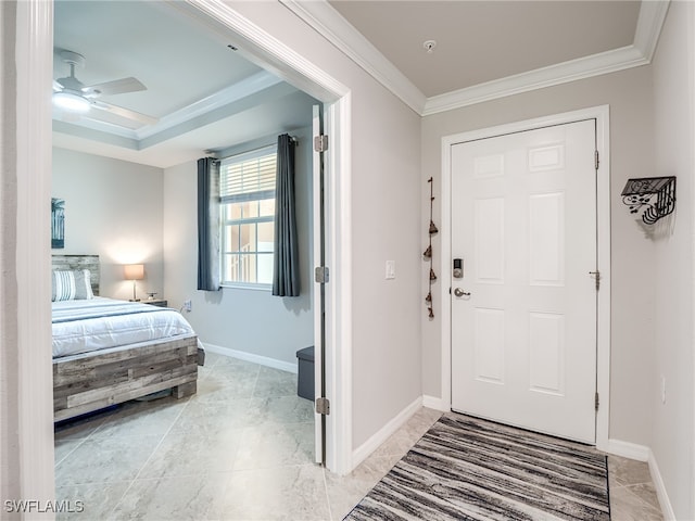 foyer entrance with ceiling fan and crown molding