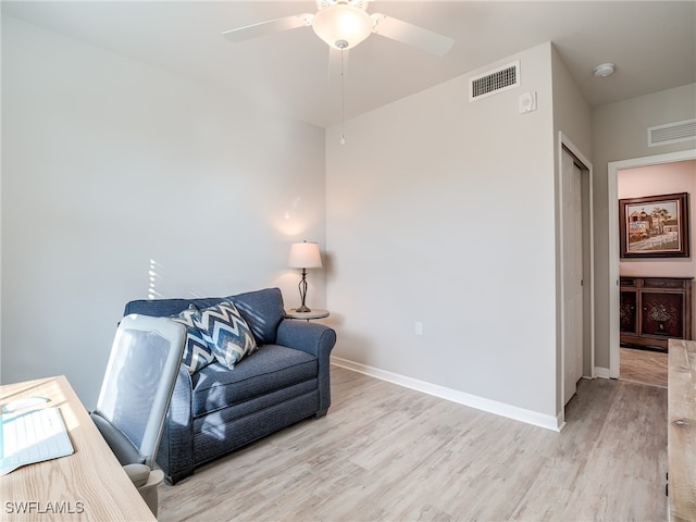 sitting room with ceiling fan and light hardwood / wood-style flooring