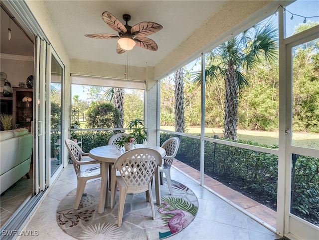 sunroom / solarium featuring ceiling fan and plenty of natural light