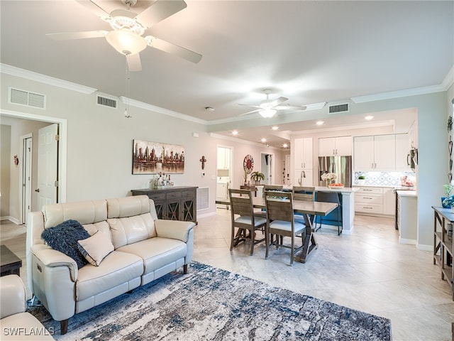 tiled living room with crown molding, ceiling fan, and washer / dryer