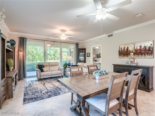 tiled dining space featuring ceiling fan and crown molding