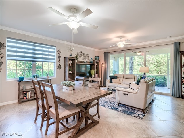 tiled dining room featuring crown molding, ceiling fan, and a healthy amount of sunlight