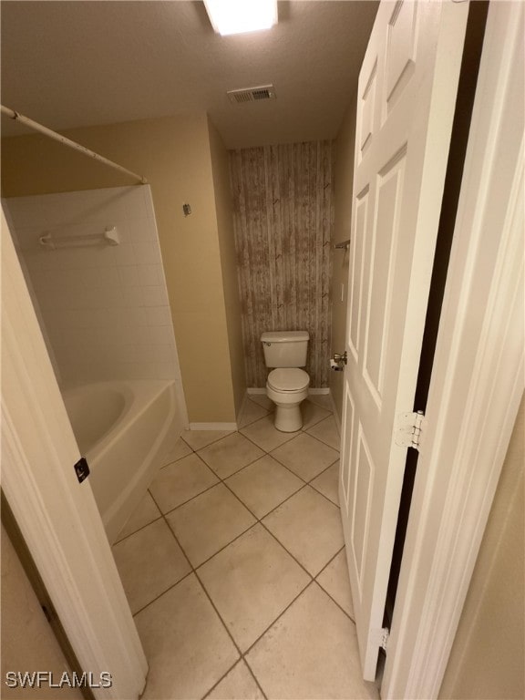 bathroom with toilet, shower / washtub combination, and tile patterned flooring