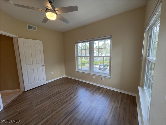 unfurnished bedroom with ceiling fan and dark hardwood / wood-style flooring