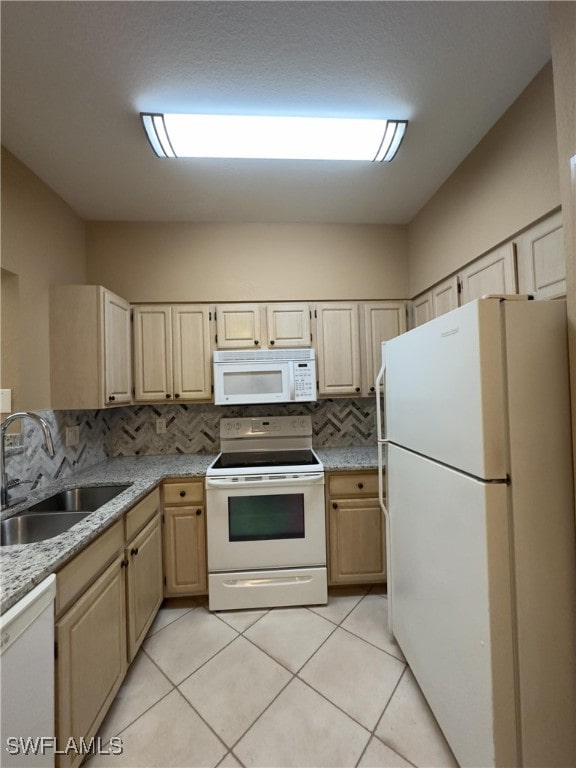 kitchen with sink, light brown cabinets, white appliances, and tasteful backsplash