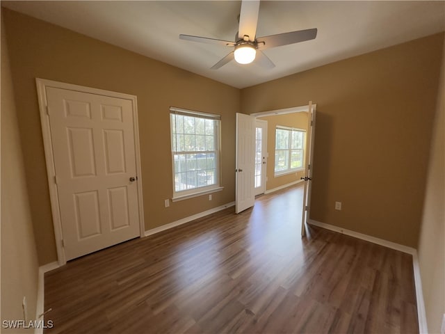 spare room featuring ceiling fan and dark hardwood / wood-style floors