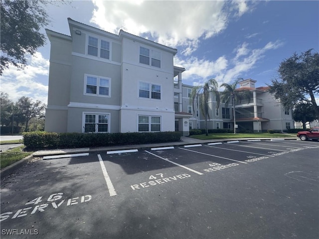 23710 Walden Center Dr Unit 201, Estero, FL 34134 - view of building exterior with uncovered parking