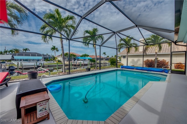 view of pool featuring a lanai and a water view