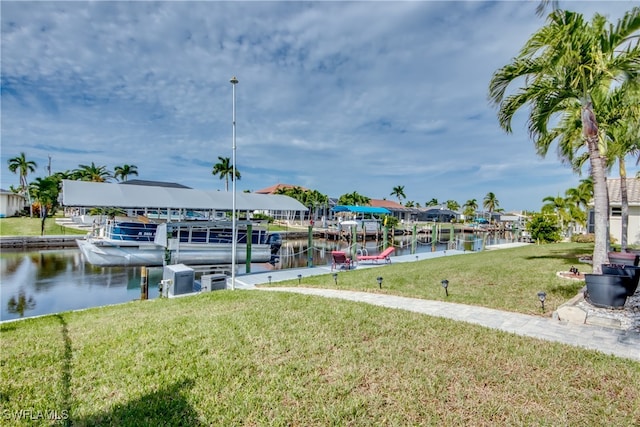 dock area with a water view and a lawn