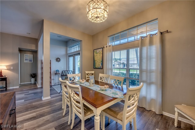 dining room featuring dark hardwood / wood-style flooring and a chandelier