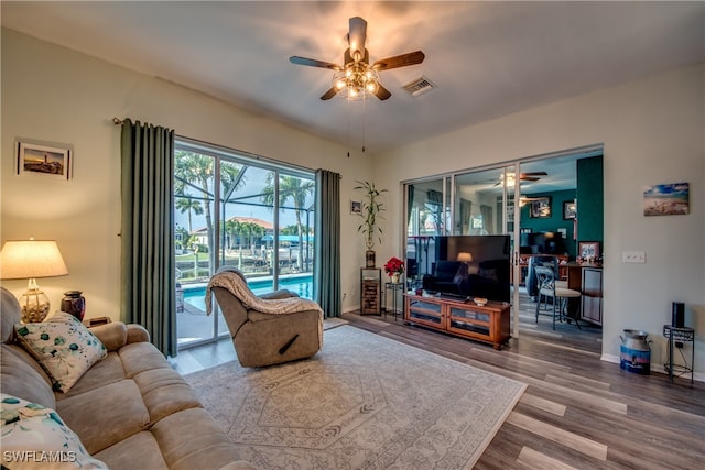 living room featuring ceiling fan and wood-type flooring