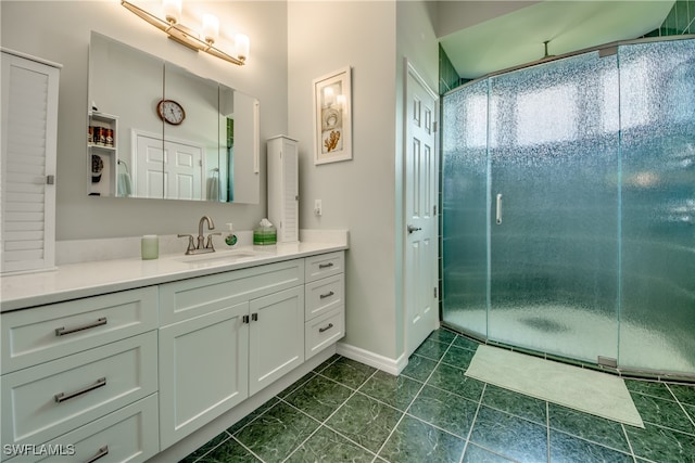 bathroom featuring tile patterned flooring, vanity, and walk in shower