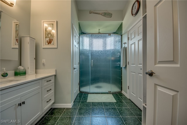 bathroom featuring tile patterned floors, vanity, and an enclosed shower