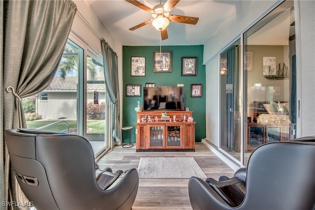 sitting room featuring ceiling fan and light hardwood / wood-style flooring