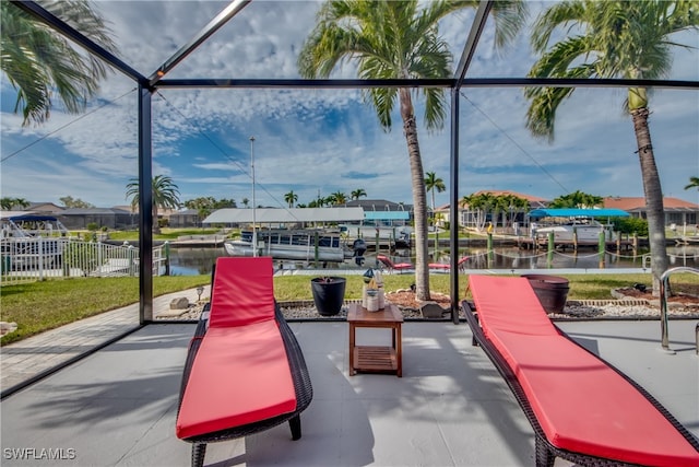 exterior space with glass enclosure and a water view