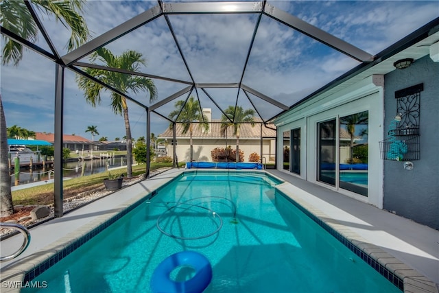 view of pool featuring a lanai and a water view