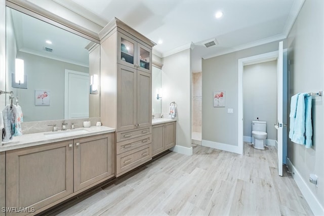 bathroom with walk in shower, ornamental molding, wood-type flooring, vanity, and toilet